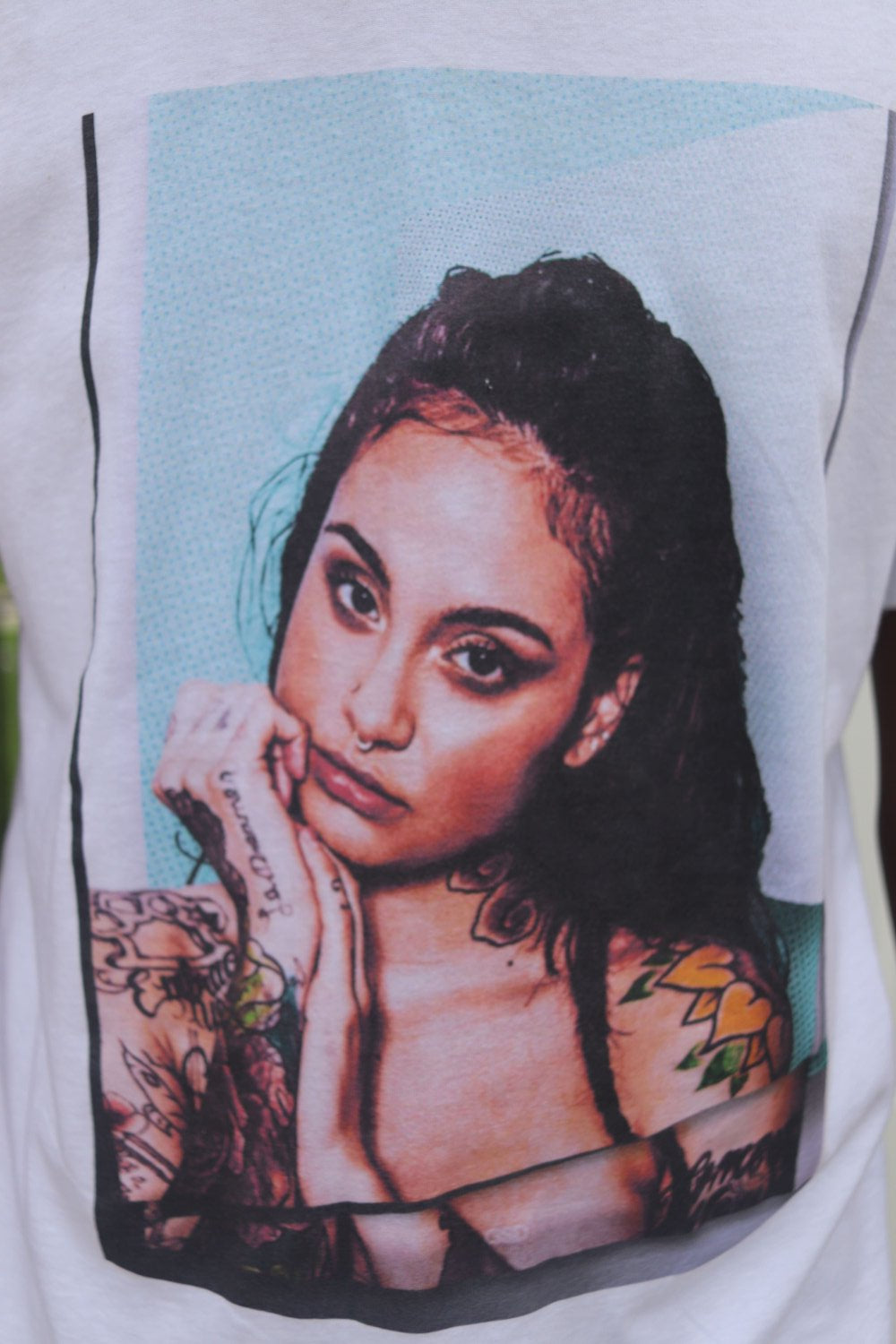 the front design of  the kehlani graphic tee in white
